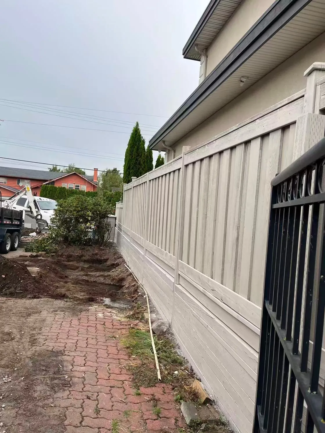 A 7,000-plus square foot home near Blundell Road and No. 5 Road in Richmond, where the fence had never been coated. The owner picked one colour for the walls and the fence, and it went on as solid stain, sprayed twice.